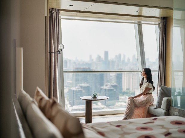 A person sitting on a couch looking out a window AI-generated content may be incorrect.